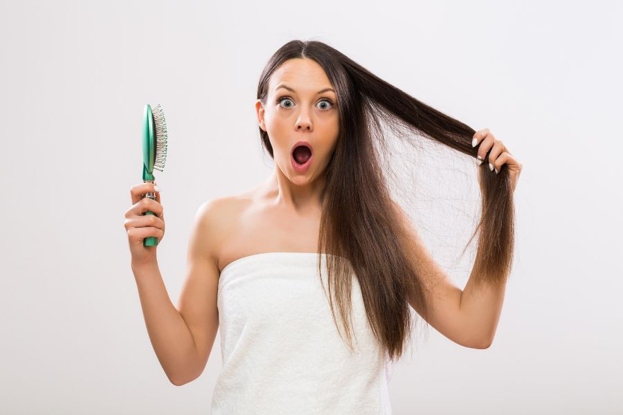woman looking confused about hair loss