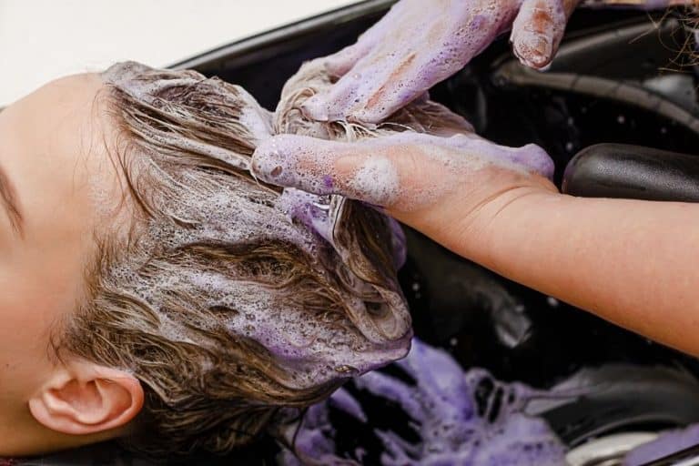 woman washing hair purple shampoo