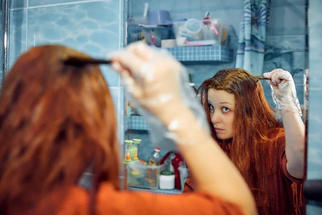 woman dying her hair with henna