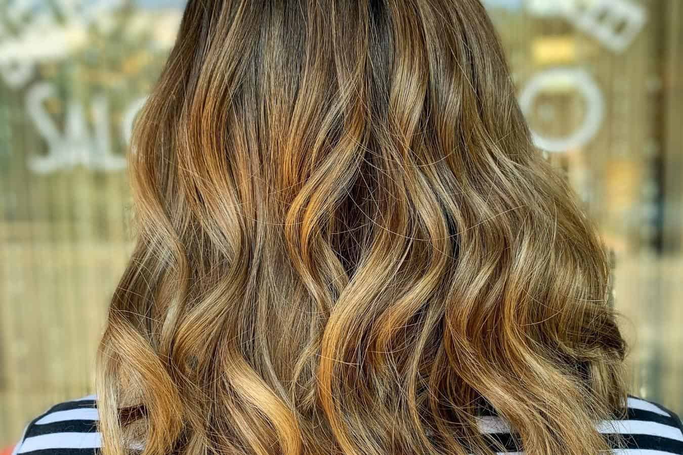 close up of a woman's hair which is colored balayage