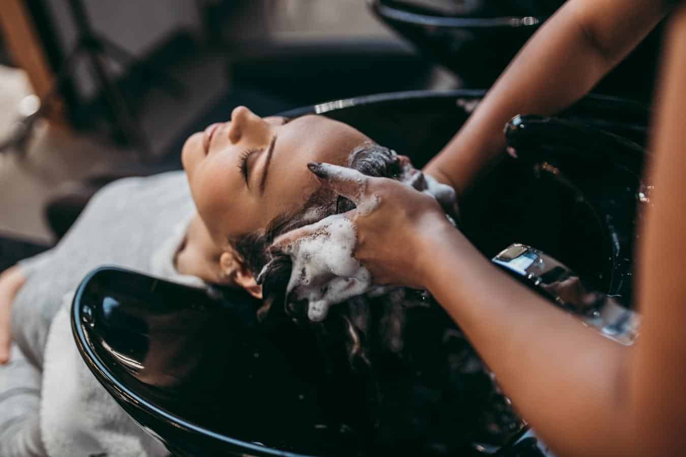 woman getting her hair washed at a salon