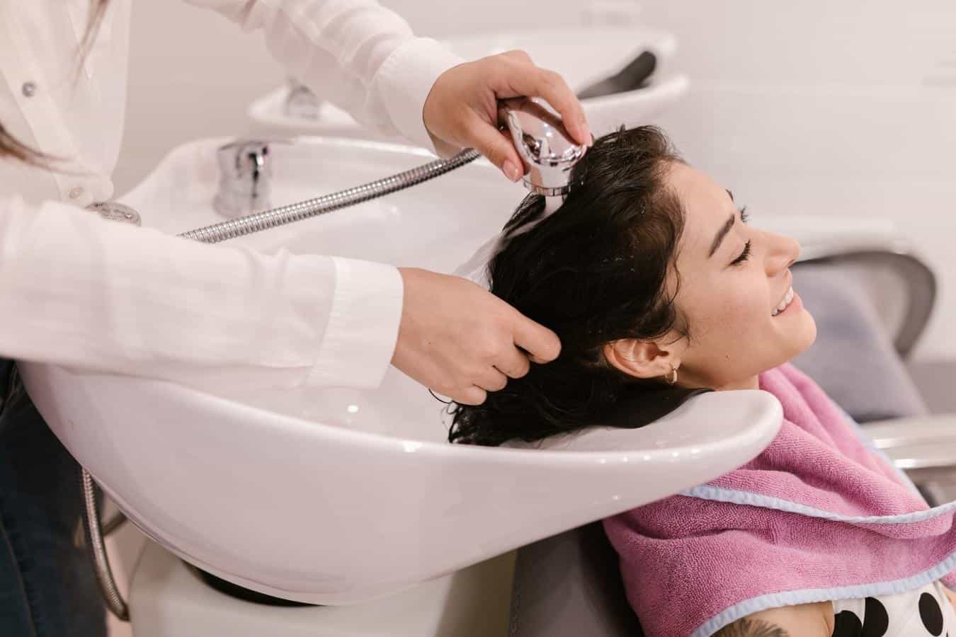 woman having her hair washed at a salon